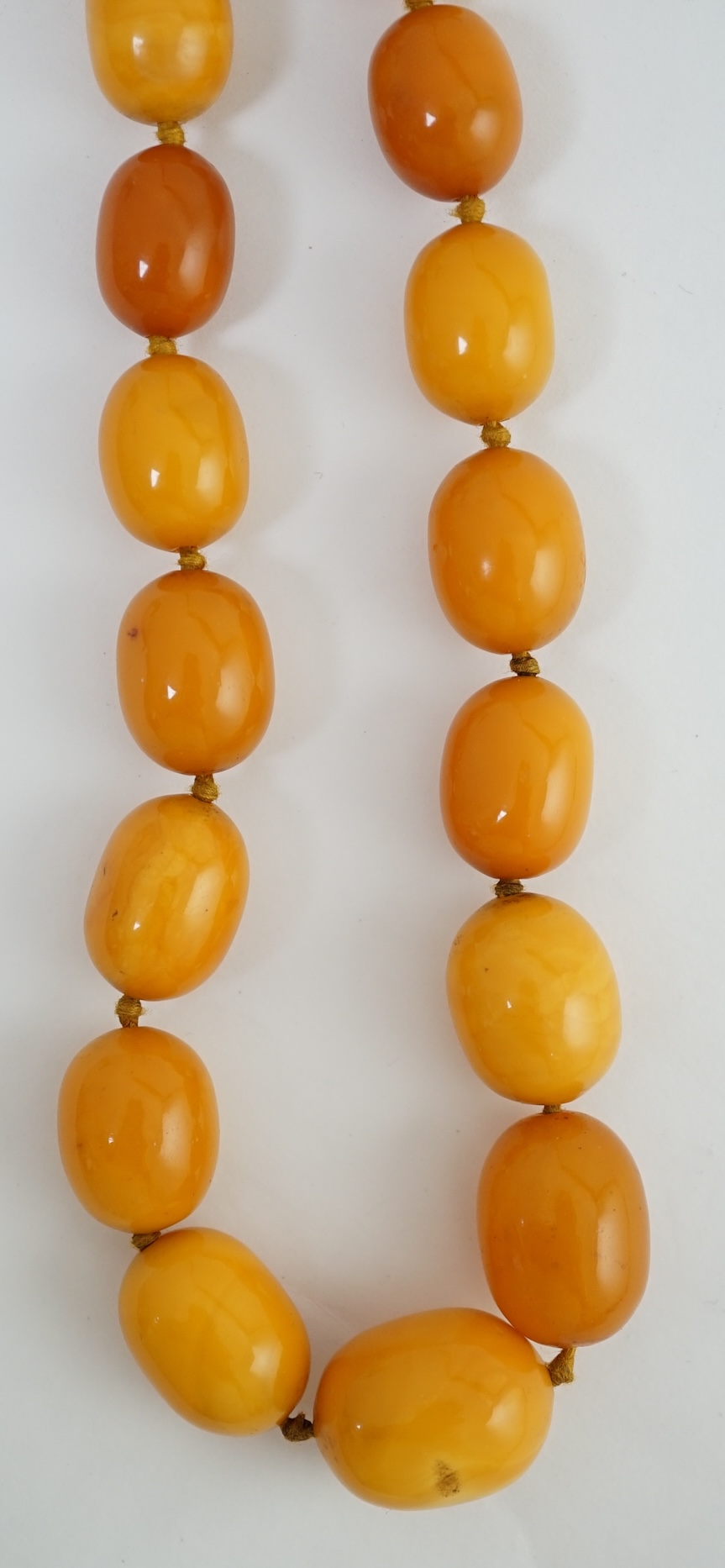 A single strand graduated oval amber bead necklace